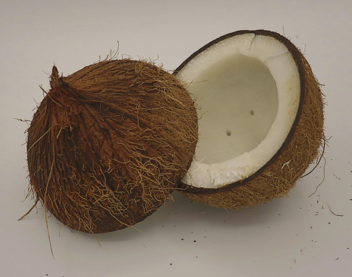 A whole coconut and a split half