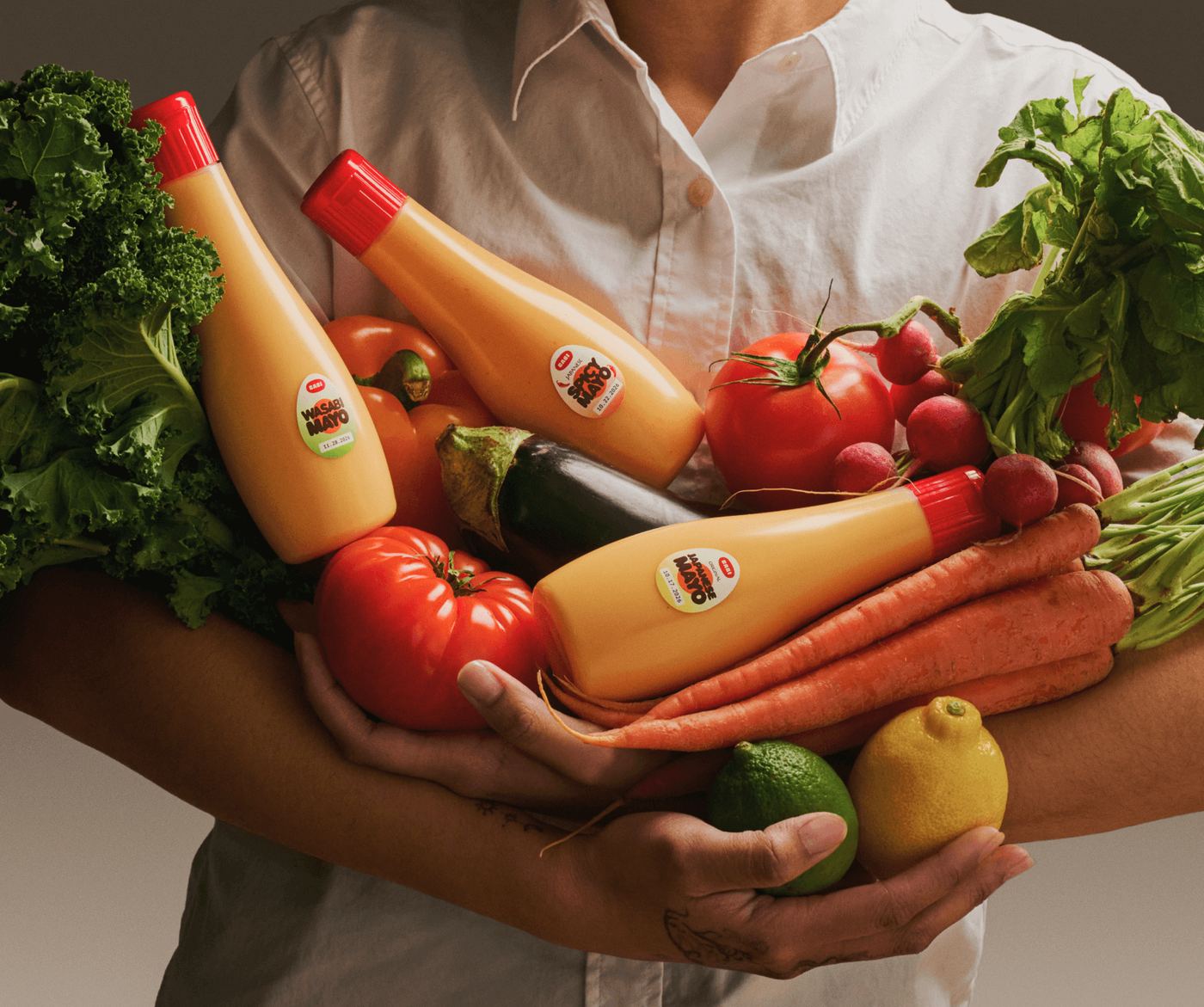 Arms full of fresh vegetables and CABI mayo bottles