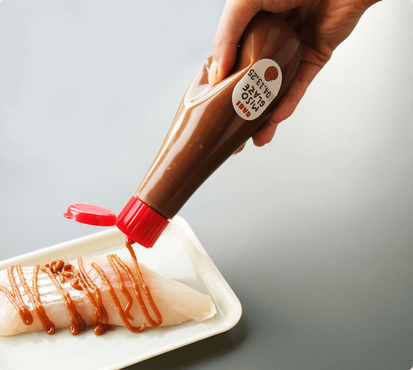 CABI Miso Glaze squeezed over white fish
