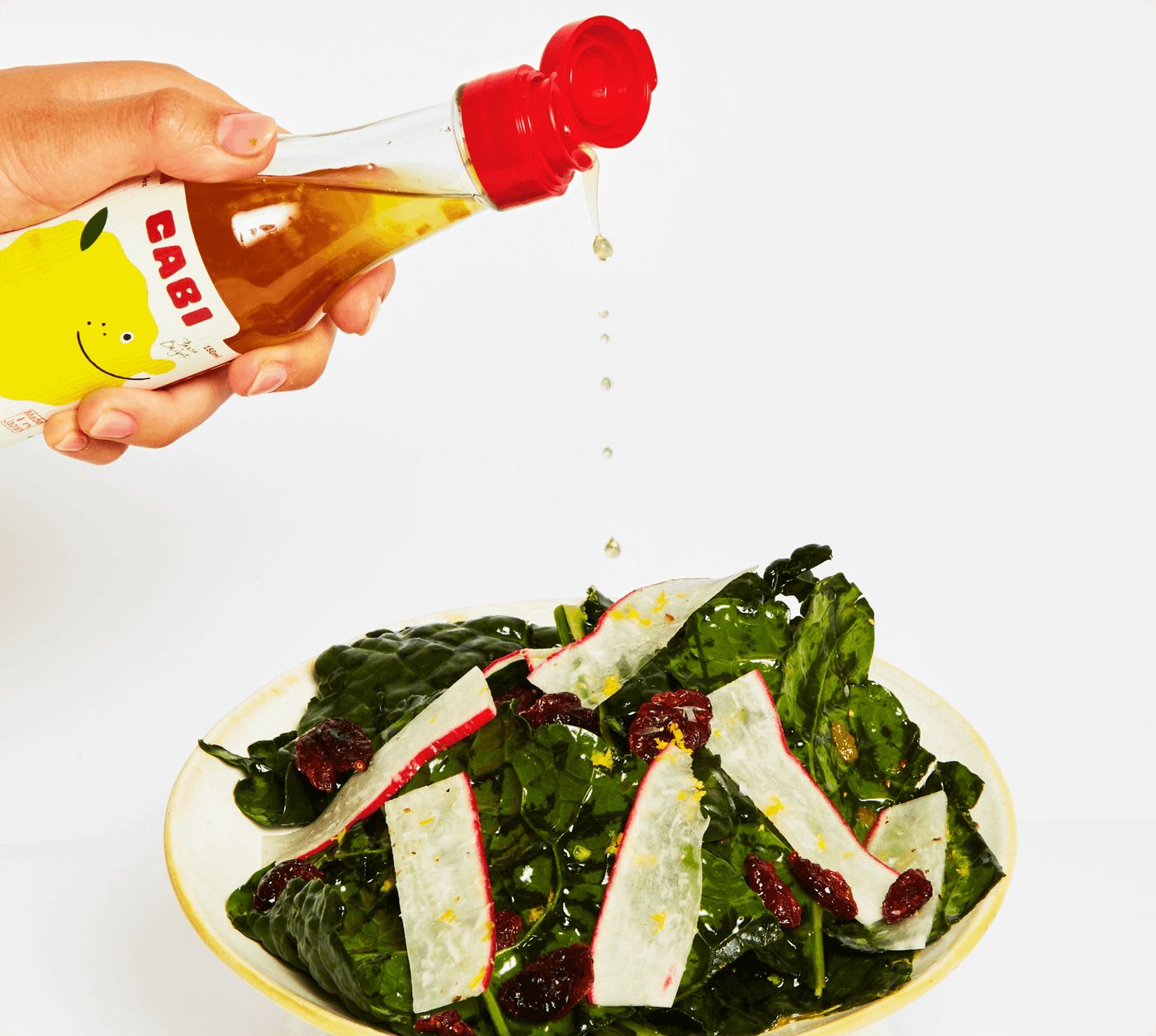 CABI Sweet Yuzu Vinaigrette poured over a green salad