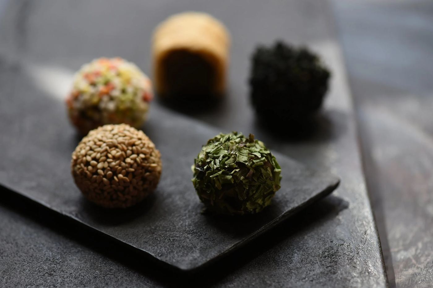 Five MISOMARU miso balls on a dark slate plate