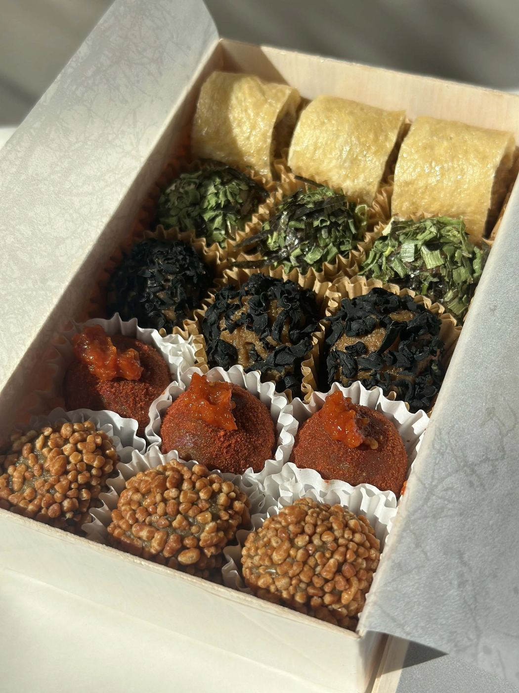 Rows of hand-rolled MISOMARU miso balls in a wooden box