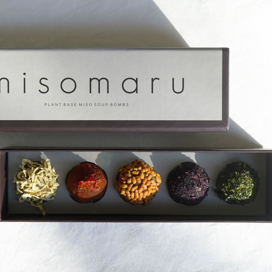 The grey MISOMARU plant-based box, open, with five miso balls