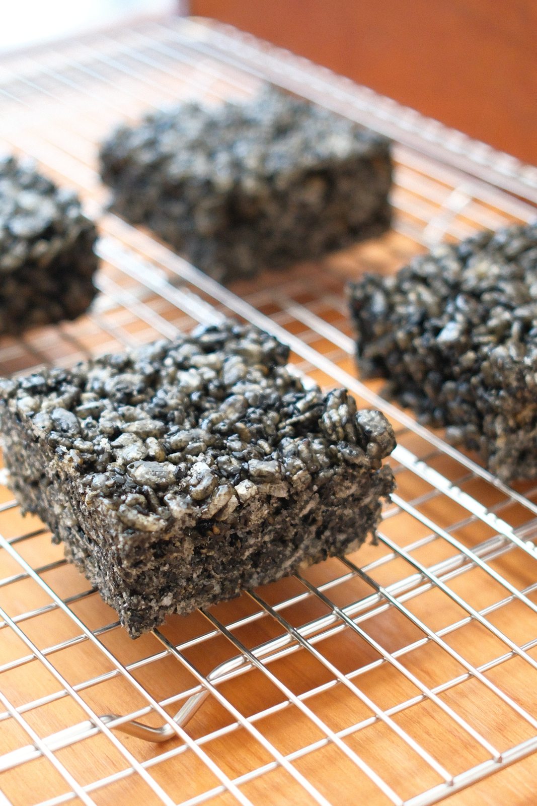 Black sesame rice crispies cooling on a rack